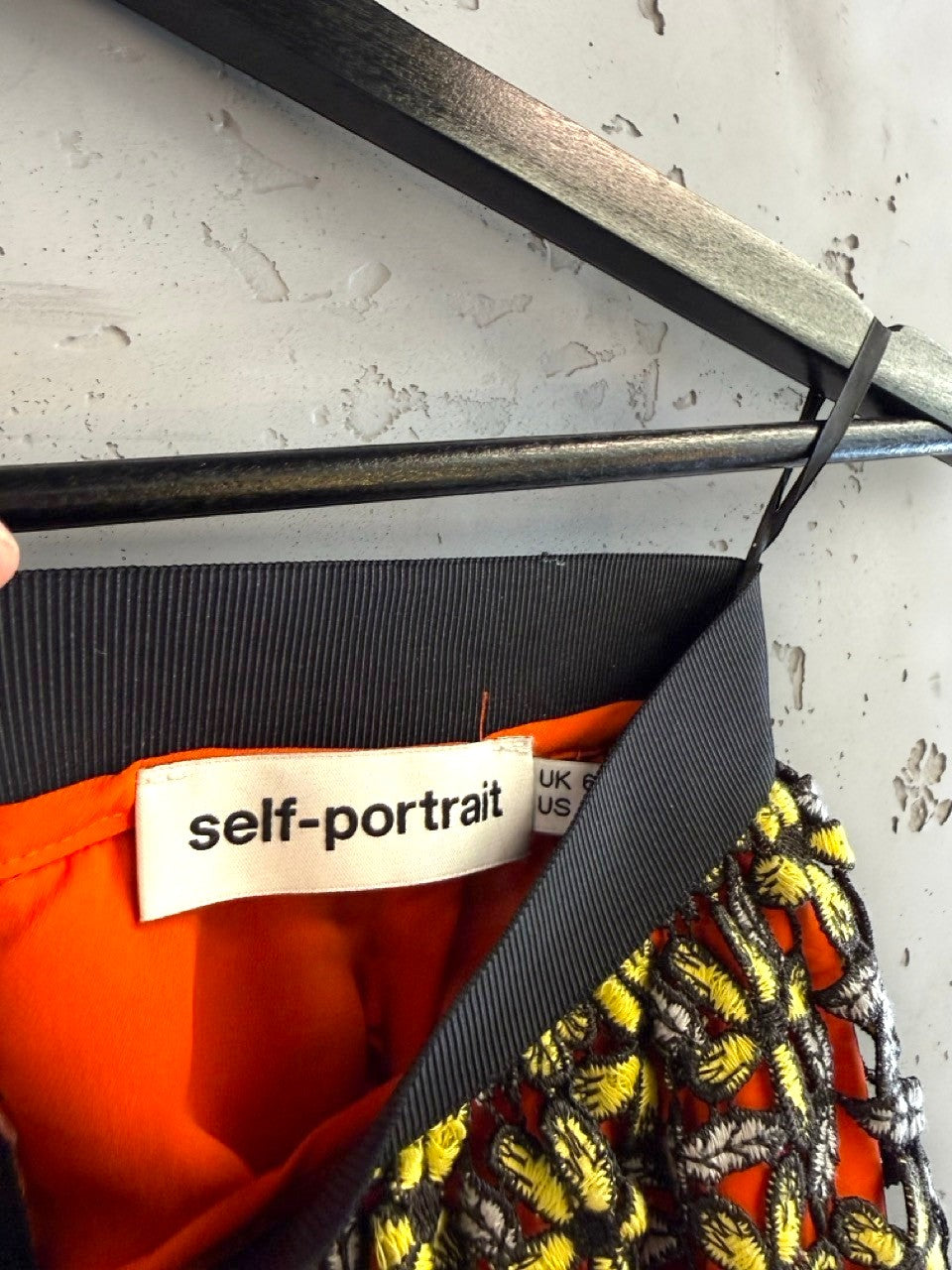 BERLIN VINTAGE CORNER Self-Portrait floral lace midi skirt with orange lining, yellow embroidery, and black elastic waistband.