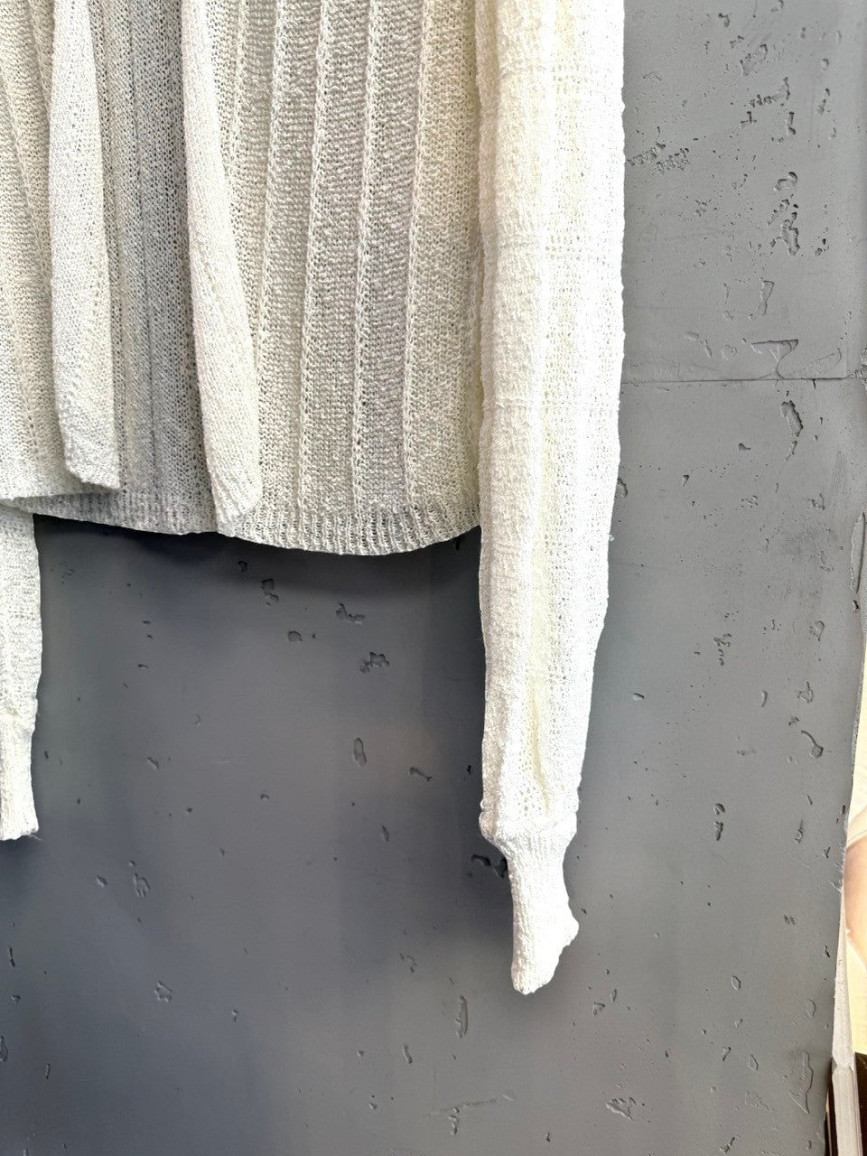 BERLIN VINTAGE CORNER off-white sheer knit long sleeve cardigan with vertical ribbing and tie detail.