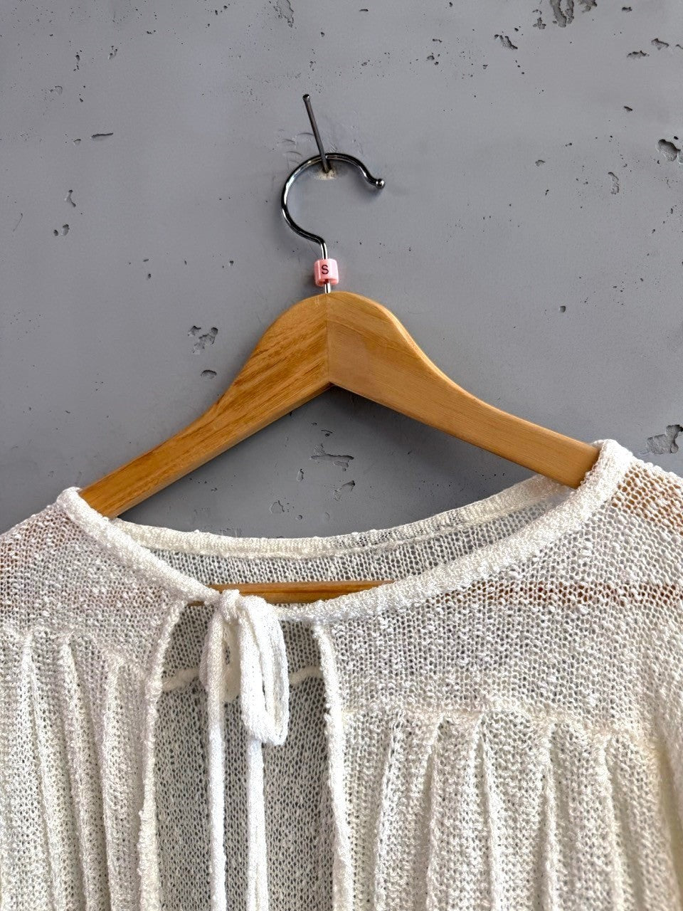 BERLIN VINTAGE CORNER off-white sheer knit long sleeve cardigan with tie detail and vertical ribbing.