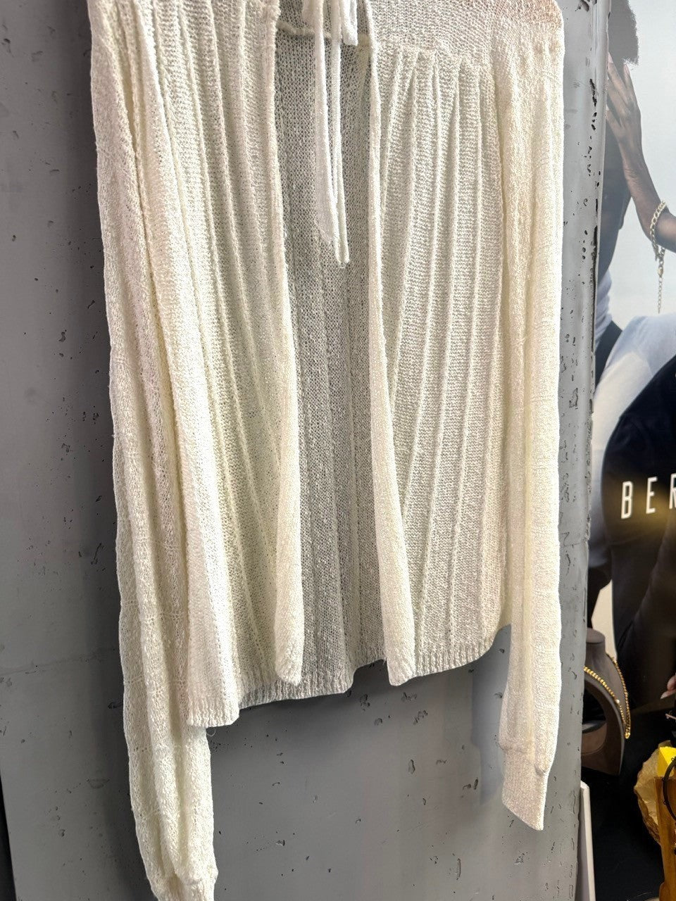 BERLIN VINTAGE CORNER off-white sheer knit long sleeve cardigan with tie neck detail and vertical ribbing.