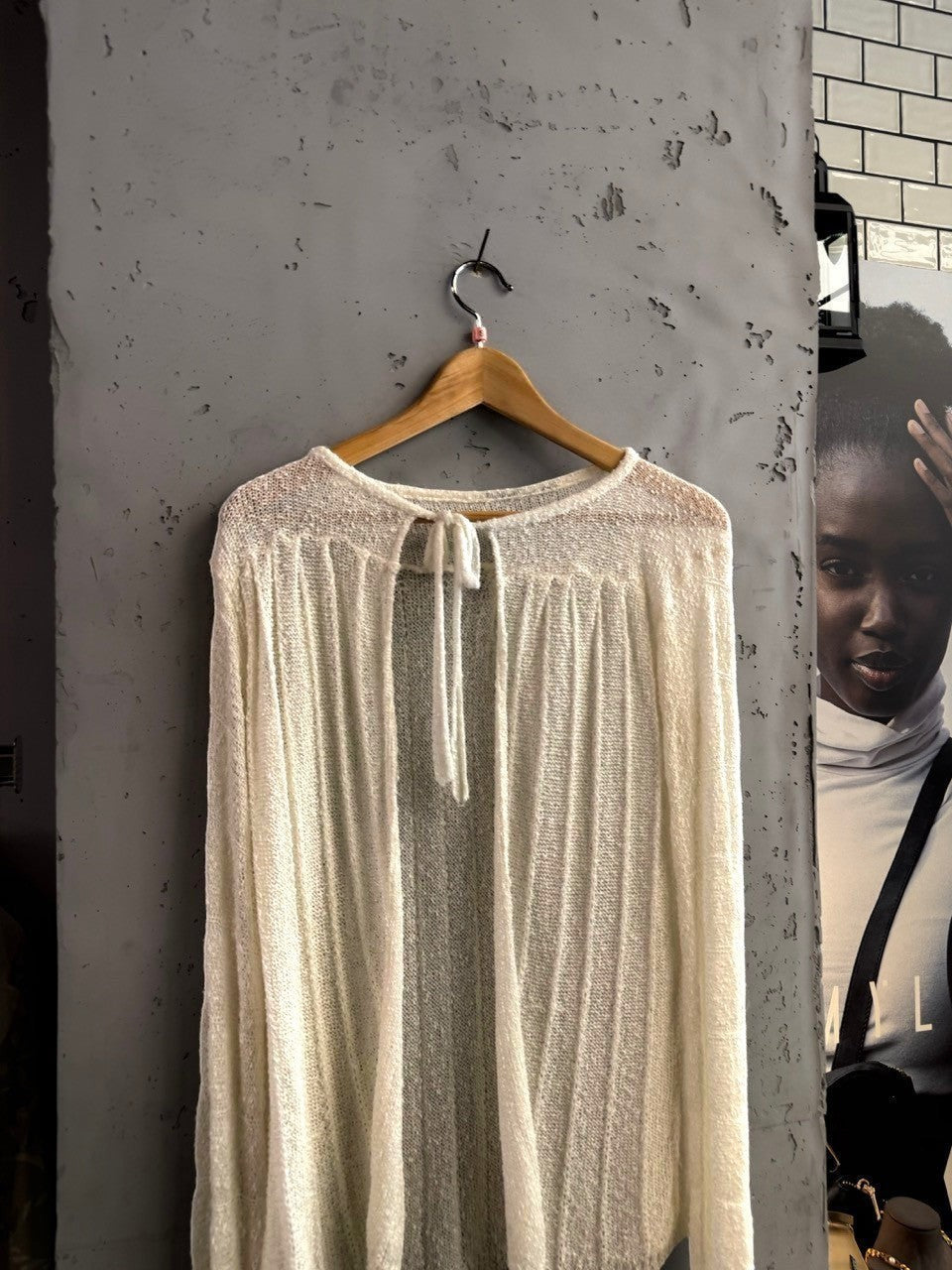 BERLIN VINTAGE CORNER off-white sheer knit long sleeve cardigan with tie neck detail and vertical ribbing.