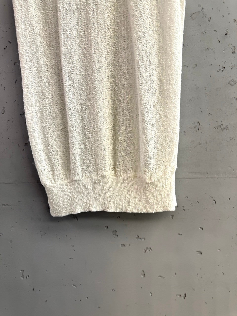 BERLIN VINTAGE CORNER off-white sheer knit sleeveless top with crew neck and textured fabric.