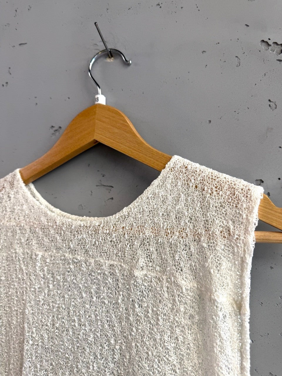 BERLIN VINTAGE CORNER off-white sheer knit sleeveless top with crew neckline and textured fabric.