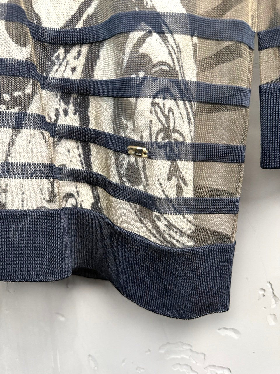 BERLIN VINTAGE CORNER sheer long-sleeved V-neck top with abstract print and navy trim.