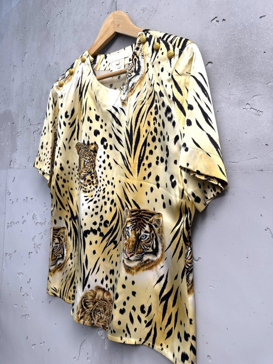 BERLIN VINTAGE CORNER silk blouse with bold tiger and leopard print, gold-tone shoulder buttons.
