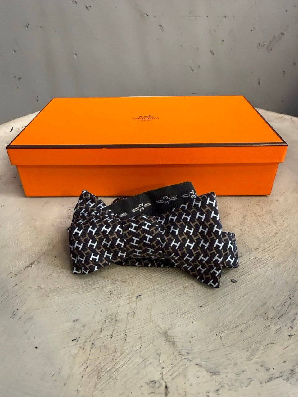 BERLIN VINTAGE CORNER black, white, and brown silk bow tie with all-over H pattern. Self-tie design.