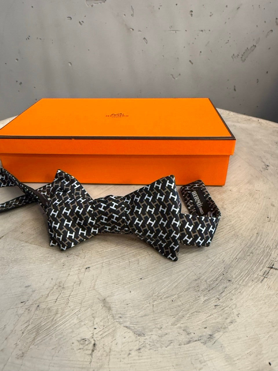 BERLIN VINTAGE CORNER black, white, and brown silk bow tie with all-over H pattern. Self-tie design.