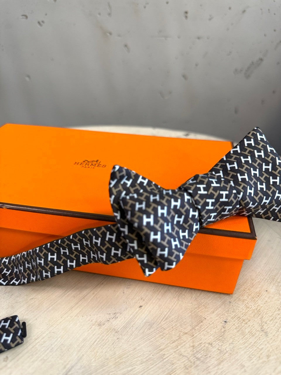 BERLIN VINTAGE CORNER black, white, and brown silk bow tie with all-over H pattern. Self-tie design.