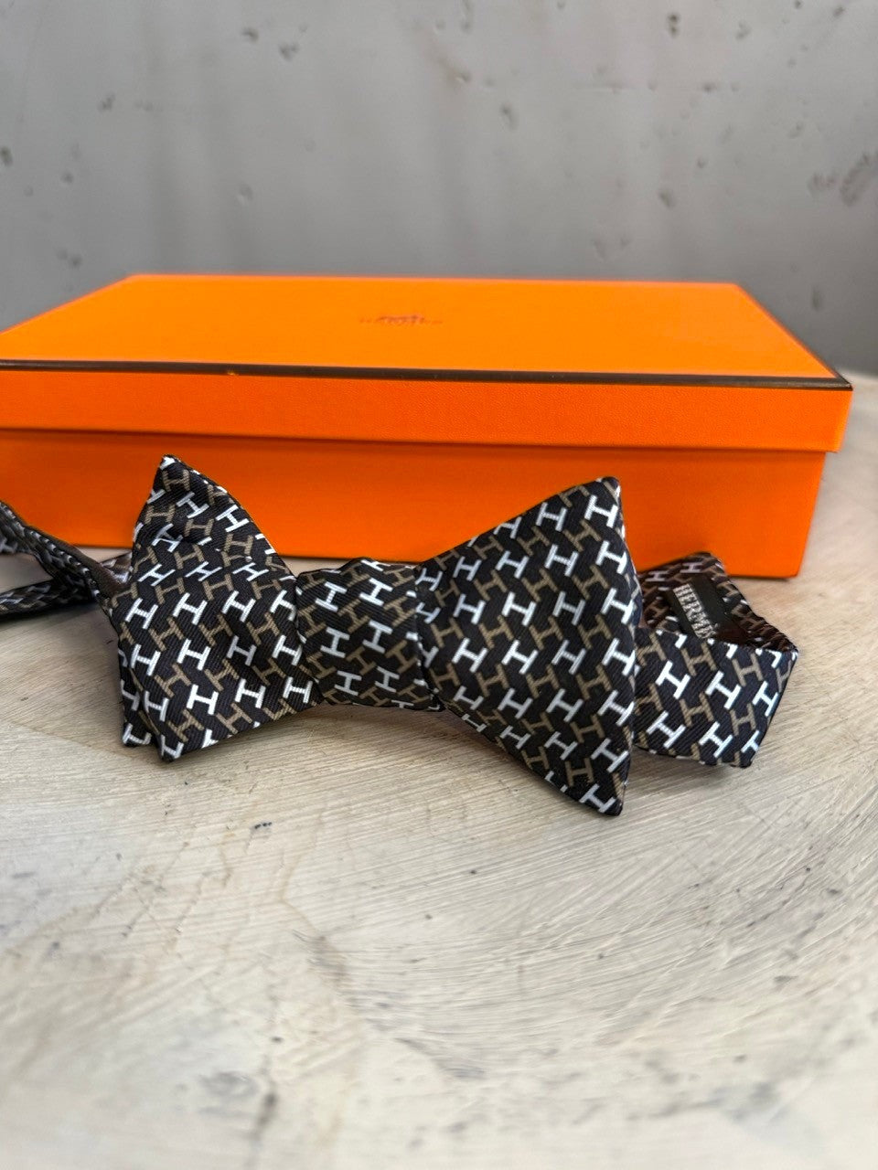 BERLIN VINTAGE CORNER black, white, and brown silk bow tie with all-over H pattern. Self-tie design.