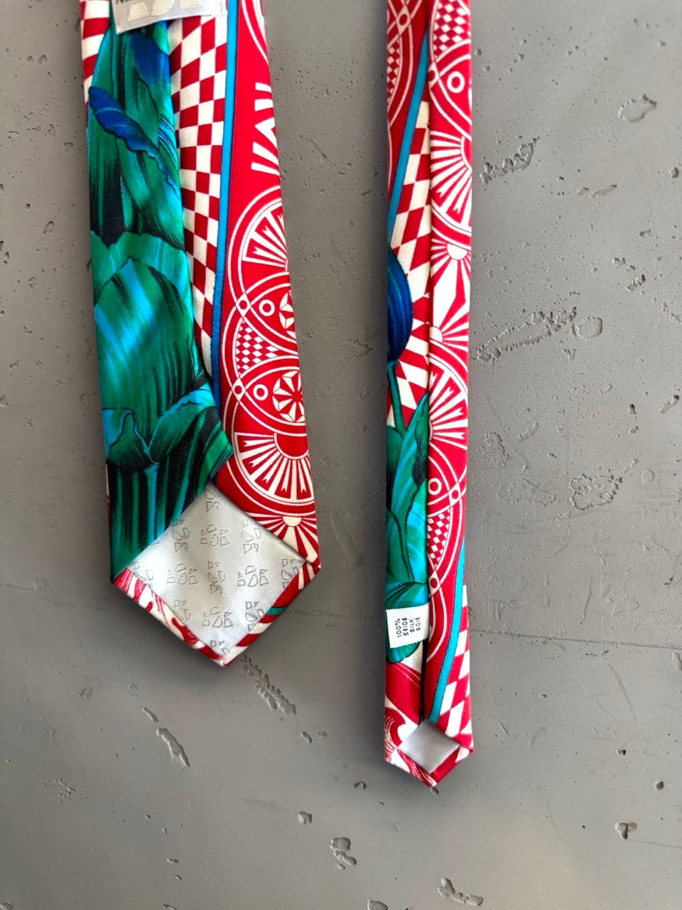 BERLIN VINTAGE CORNER Anne Surkamp Kramer silk necktie featuring red, teal, and white geometric and botanical prints.
