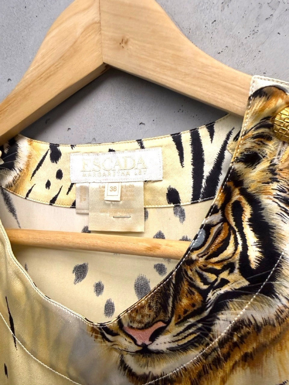 BERLIN VINTAGE CORNER silk blouse with a bold tiger print and gold-tone shoulder buttons.