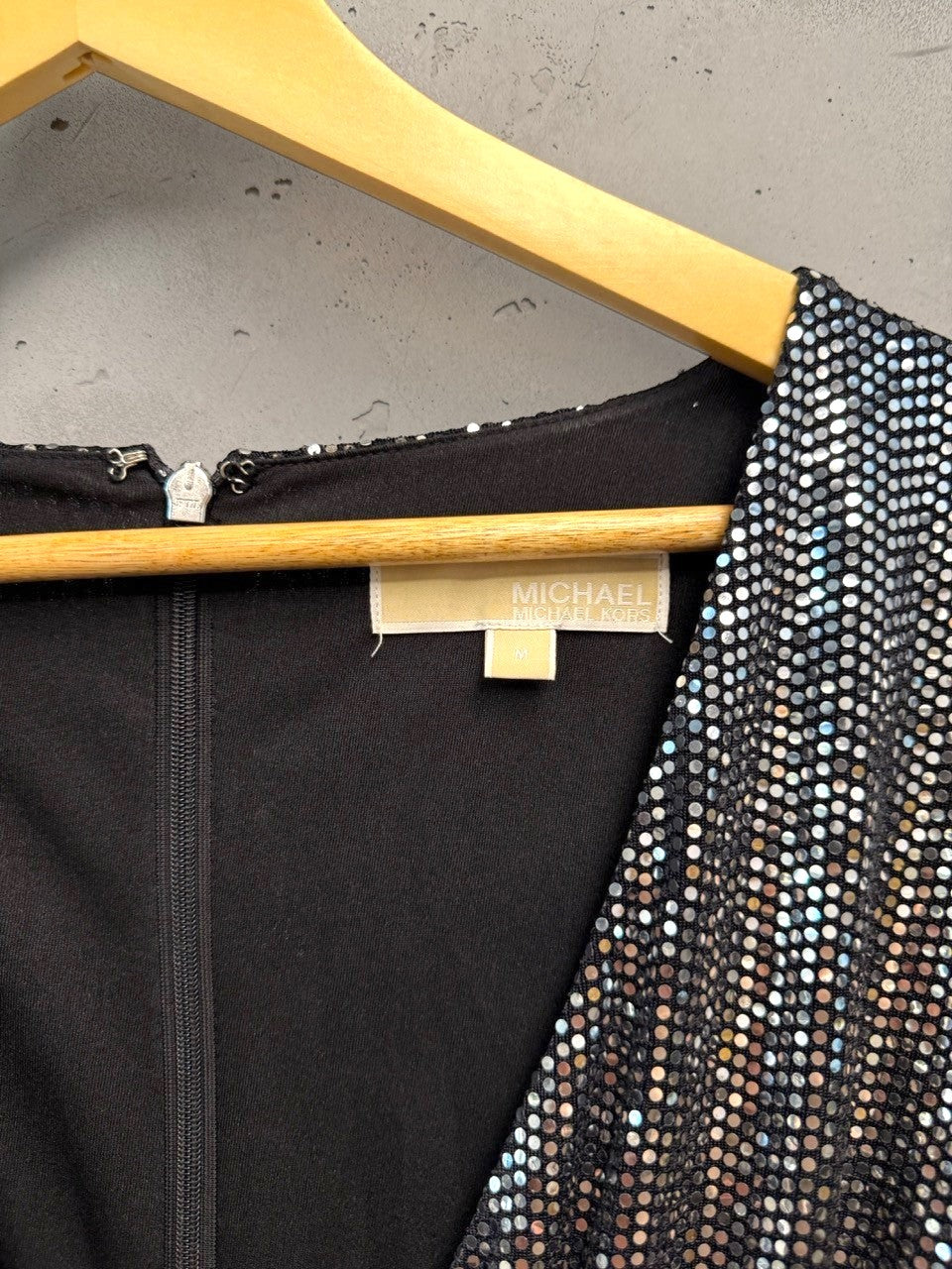 BERLIN VINTAGE CORNER silver sequin wrap dress with V-neckline, long sleeves, and ruffled hem.