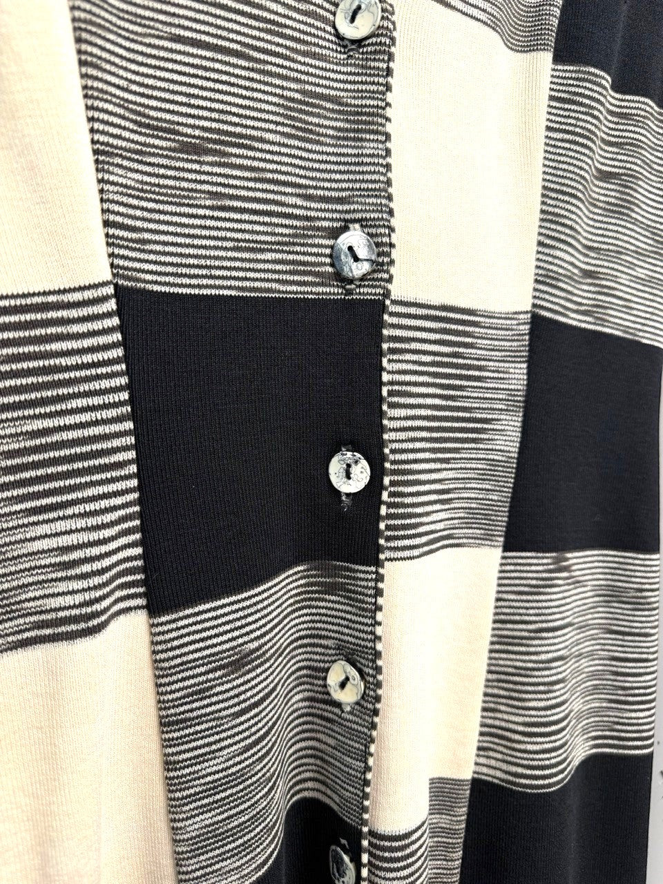 BERLIN VINTAGE CORNER sleeveless knit vest with black, white, and cream checkerboard pattern and shell buttons.