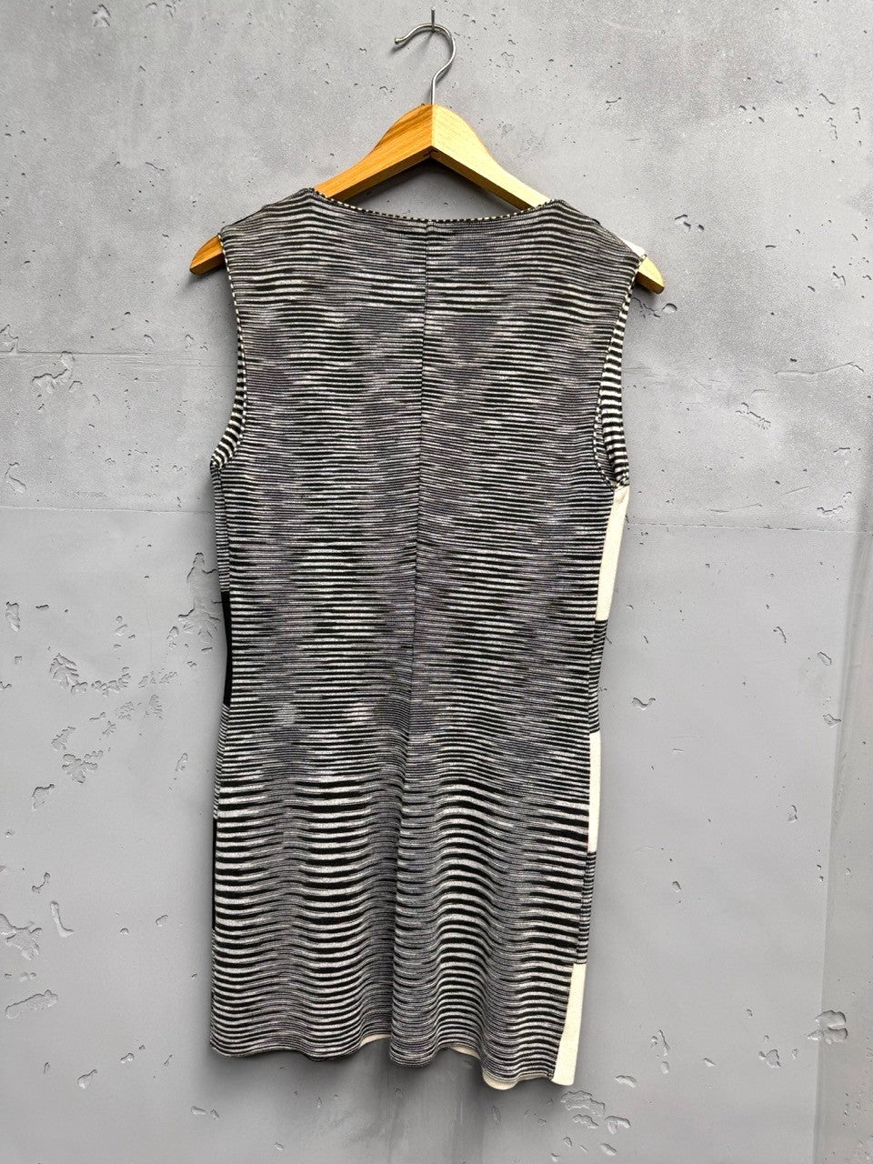 BERLIN VINTAGE CORNER sleeveless knit vest with horizontal stripes in black, white, and cream. V-neck, button front.