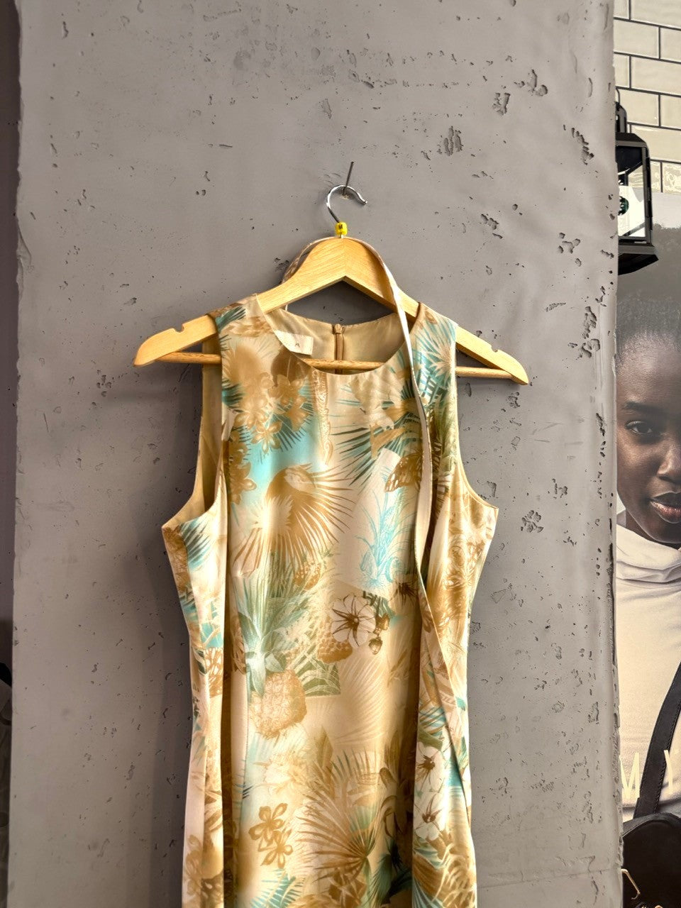 BERLIN VINTAGE CORNER sleeveless midi dress with a tropical print in beige, tan, and turquoise. Flowing fabric.