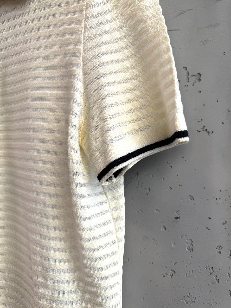 BERLIN VINTAGE CORNER cream knit polo shirt with black trim on collar and cuffs, short sleeves, horizontal stripes.