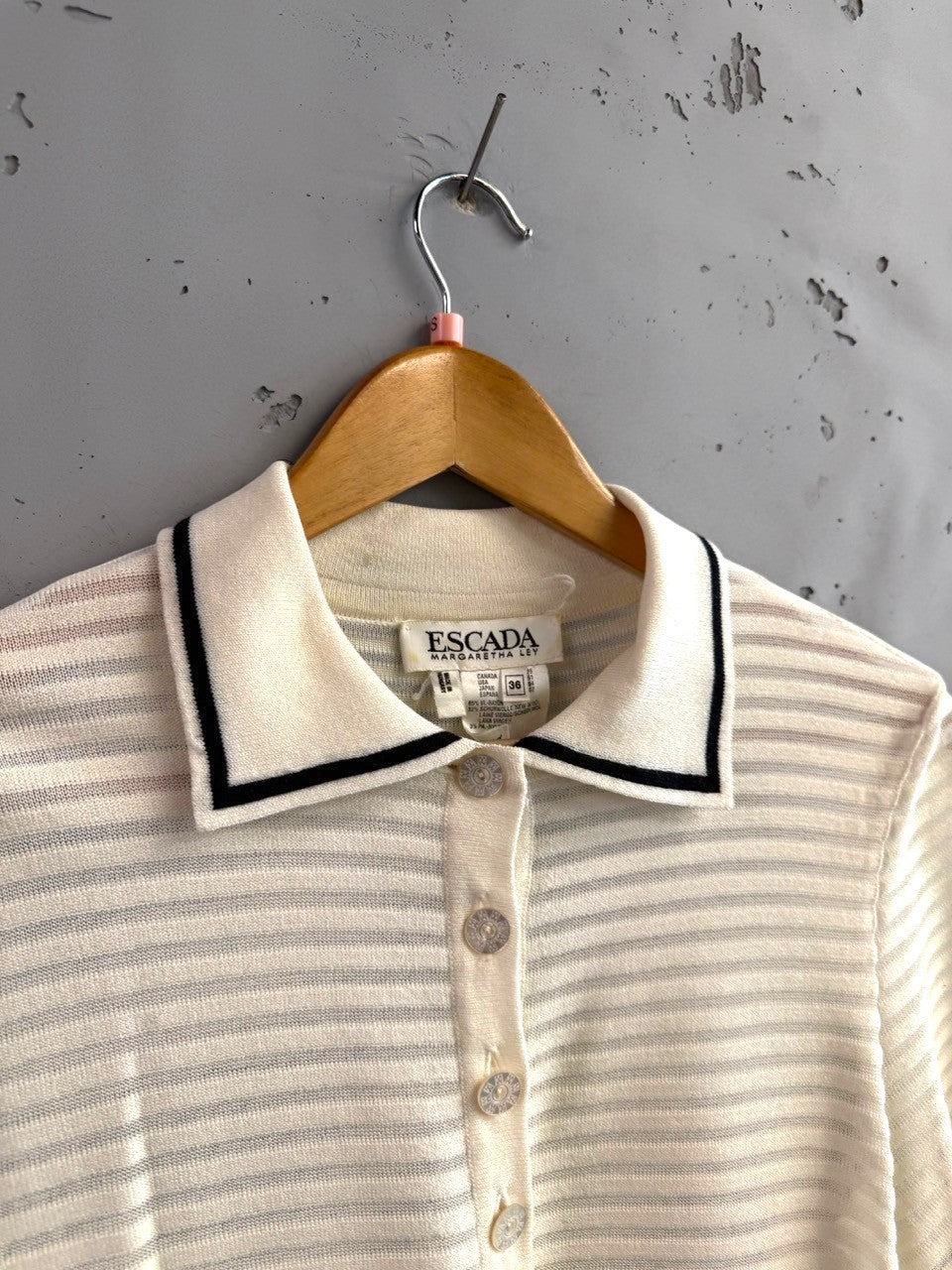 BERLIN VINTAGE CORNER cream knit polo shirt with black trim and horizontal stripes. Short sleeves, button placket.