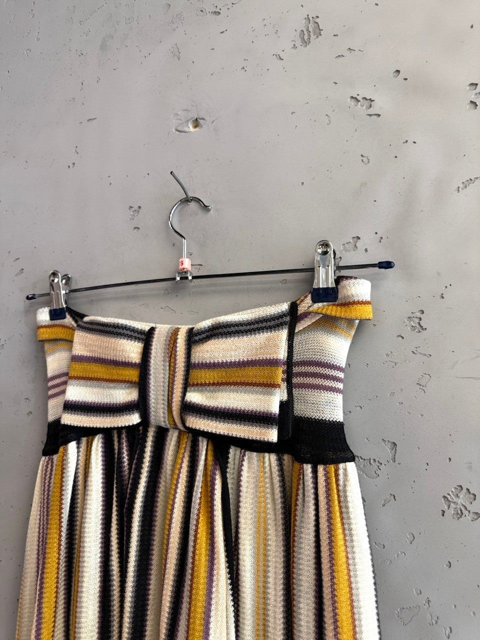 BERLIN VINTAGE CORNER strapless knit midi dress with multi-colored vertical stripes in cream, mustard, purple, and black.