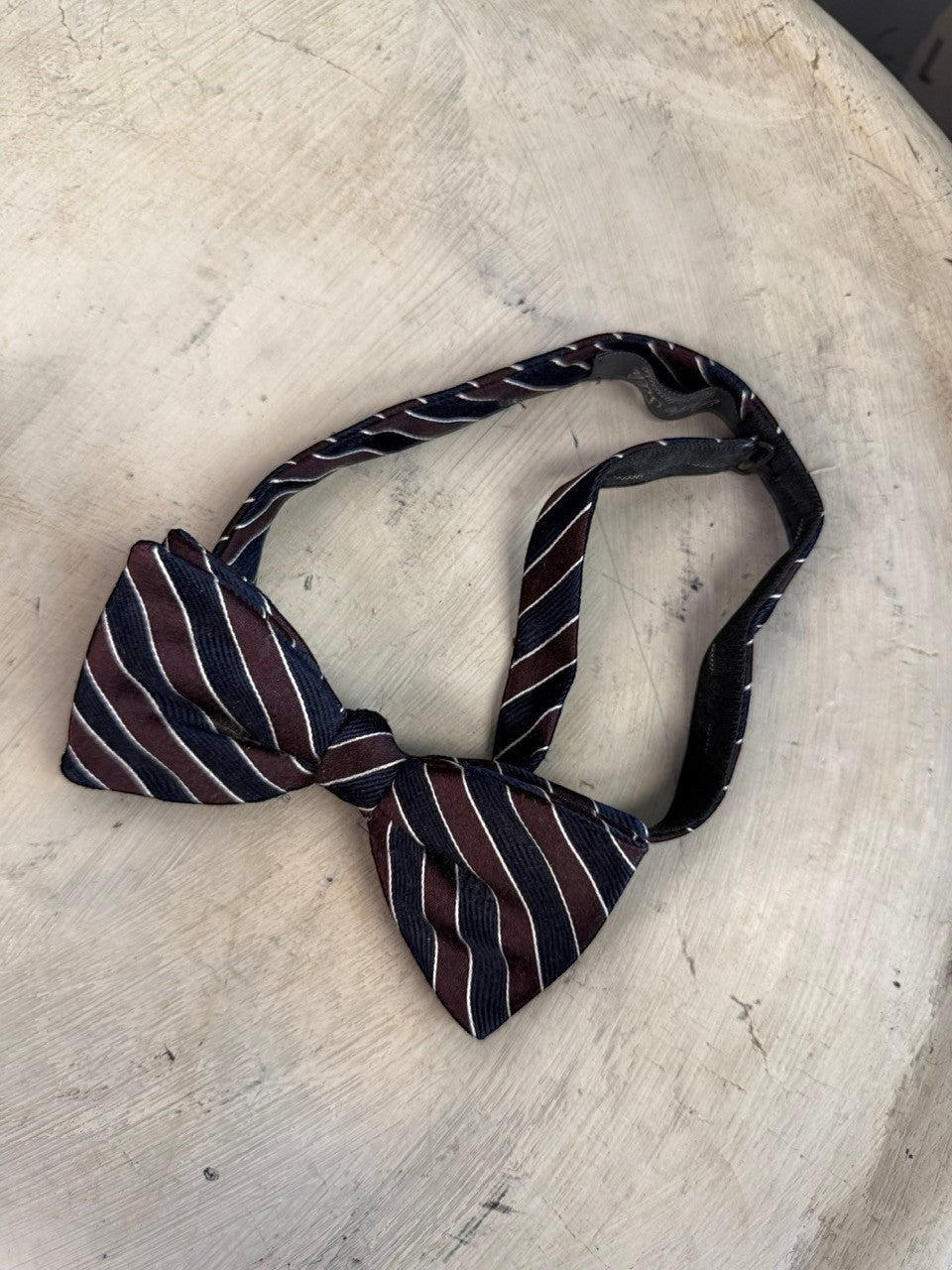 BERLIN VINTAGE CORNER handmade navy, burgundy, and white striped silk bow tie with adjustable strap.