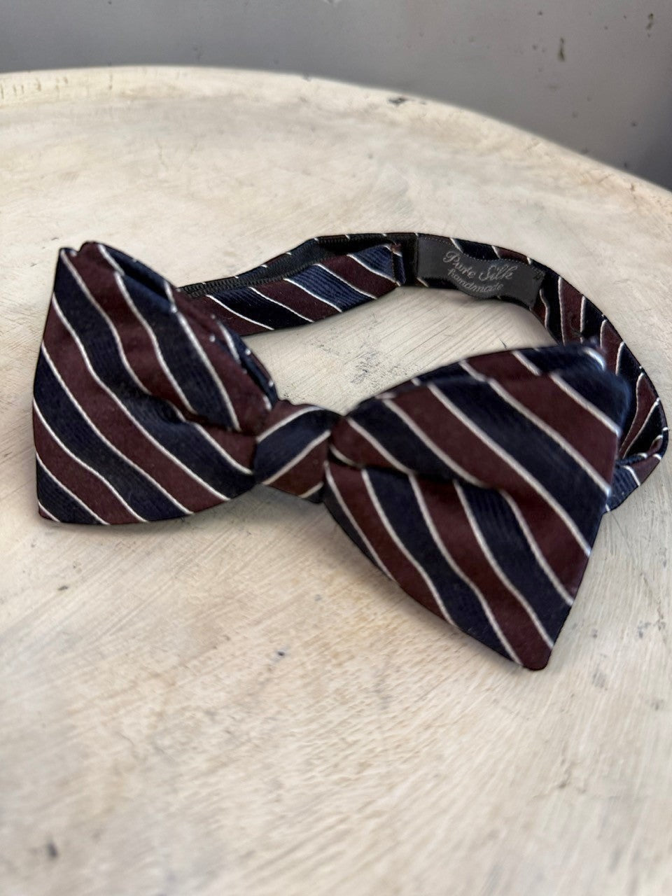 BERLIN VINTAGE CORNER handmade 100% silk bow tie with navy, burgundy, and white stripes. Adjustable strap.