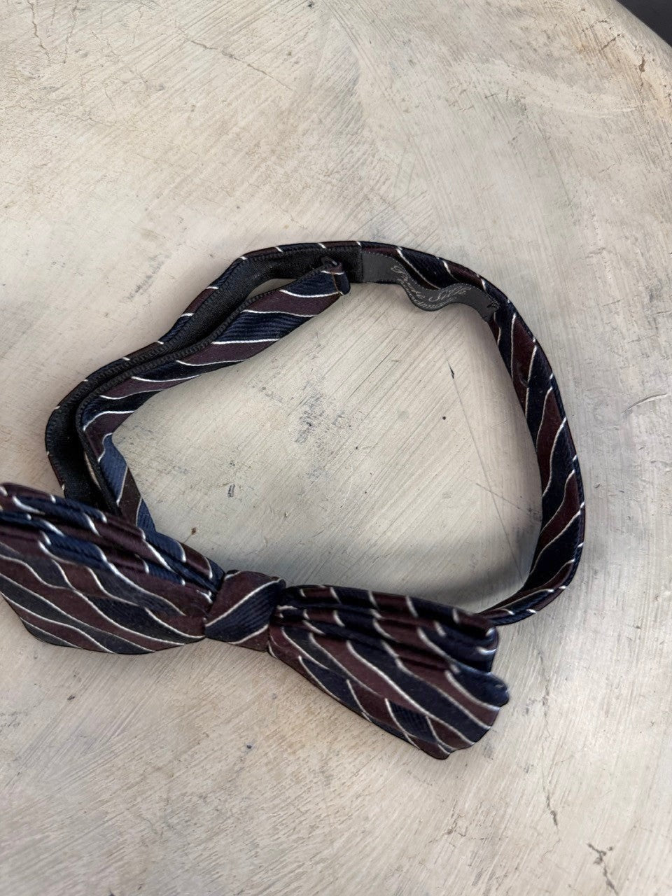 BERLIN VINTAGE CORNER handmade navy, burgundy, and white striped silk bow tie with adjustable strap.