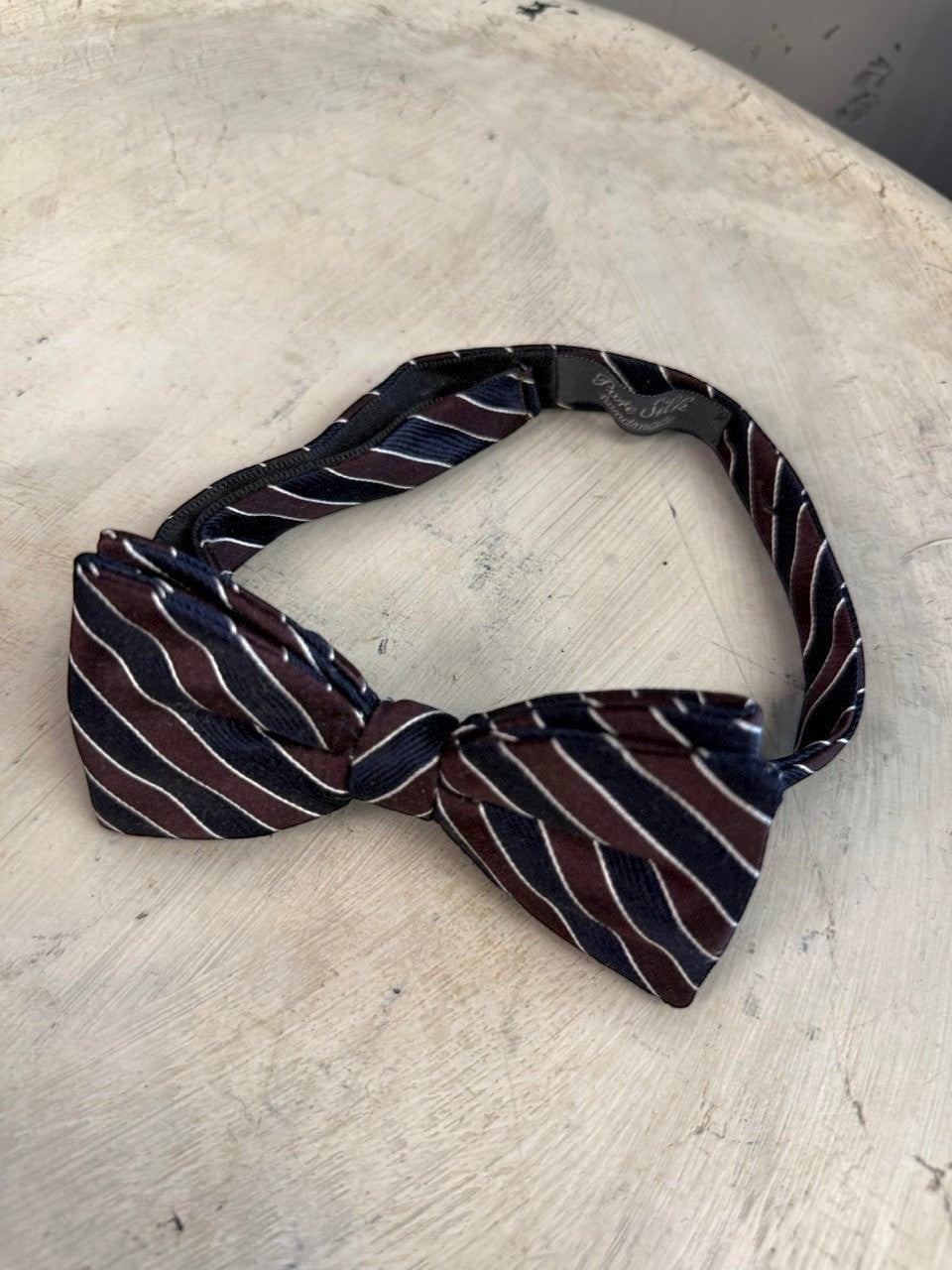 BERLIN VINTAGE CORNER handmade striped silk bow tie in navy, burgundy, and white. Adjustable strap.