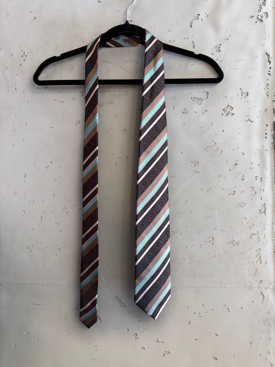 BERLIN VINTAGE CORNER brown, white, and turquoise silk necktie with diagonal stripes and paisley motif.