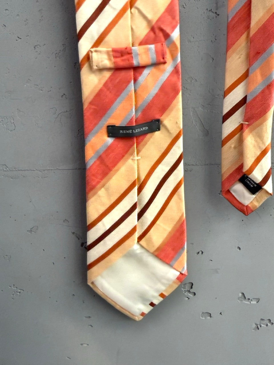 BERLIN VINTAGE CORNER men's silk necktie with diagonal stripes in peach, coral, cream, brown, grey, and blue.