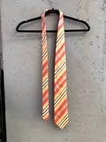 BERLIN VINTAGE CORNER men's silk necktie with diagonal stripes in peach, coral, cream, and brown.