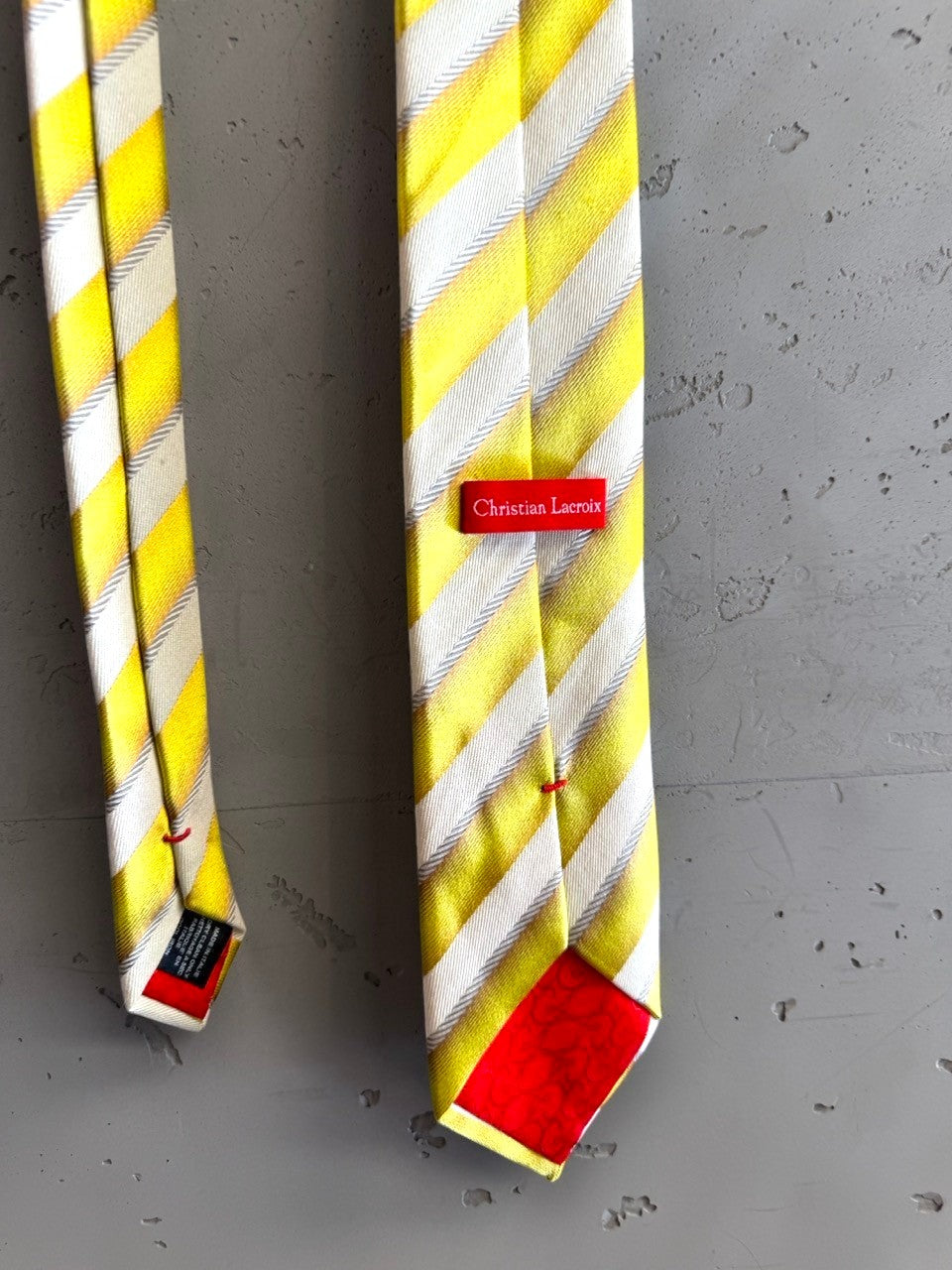 BERLIN VINTAGE CORNER yellow, white, and grey striped silk necktie with a red Christian Lacroix label.