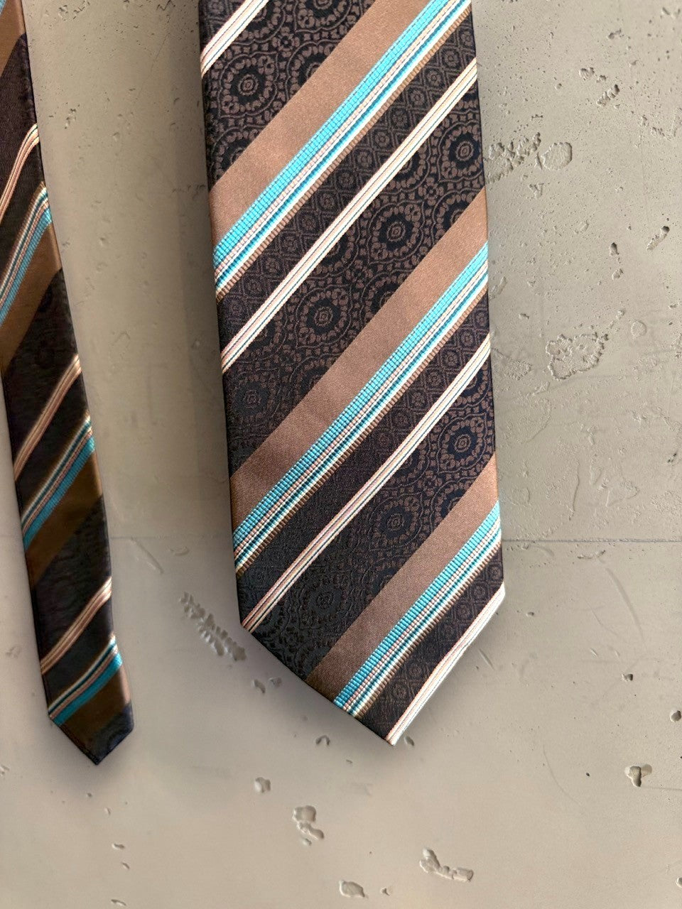 BERLIN VINTAGE CORNER brown silk tie with diagonal stripes of turquoise, white, and tan, featuring a paisley pattern. Classic width.