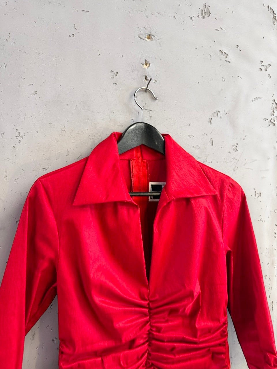 BERLIN VINTAGE CORNER TADASHI red long sleeve collared blouse with front ruched detailing on a black hanger