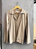BERLIN VINTAGE CORNER taupe long sleeve button-up shirt with pintuck detail and embroidered logo on hem.