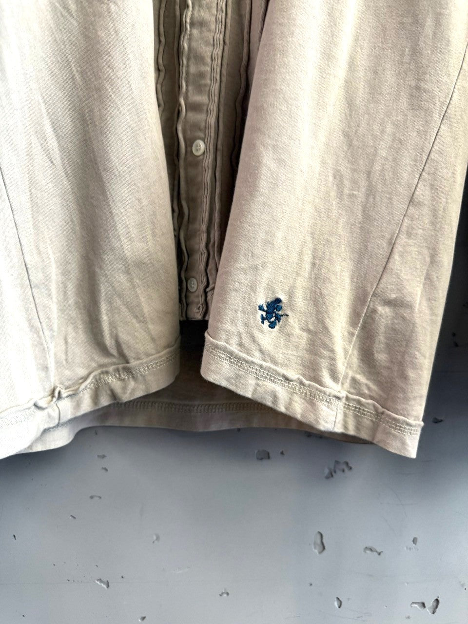 BERLIN VINTAGE CORNER taupe long sleeve button-up shirt with pintuck detail and embroidered logo on sleeve.