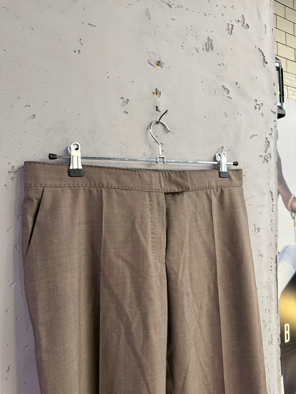 BERLIN VINTAGE CORNER taupe tailored straight leg trousers with a pressed crease and side pockets hanging on a rack.