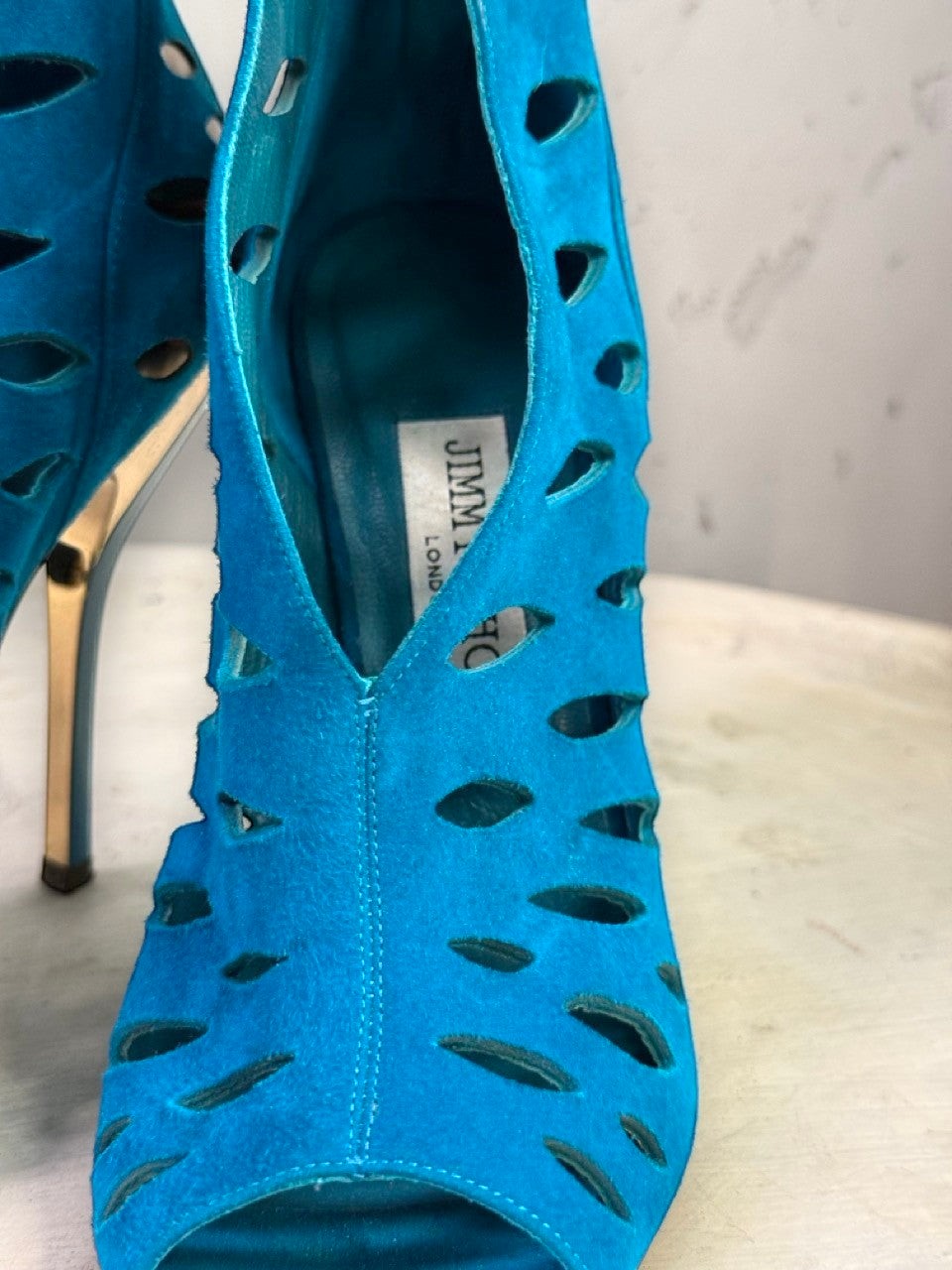 BERLIN VINTAGE CORNER teal suede Jimmy Choo peep-toe booties with intricate laser-cut patterns and gold stiletto heels.