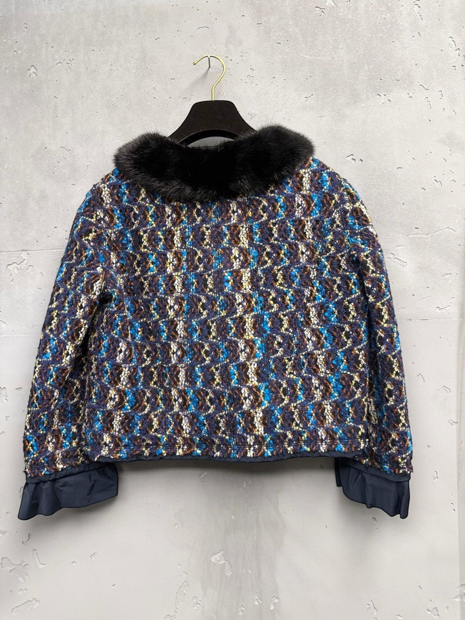 BERLIN VINTAGE CORNER textured tweed cropped jacket with black fur collar and ruffled cuffs in blue, brown, and yellow.