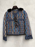 BERLIN VINTAGE CORNER textured cropped jacket in blue, brown, and yellow tweed with black fur collar and pom-poms, ruffled cuffs.