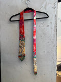 BERLIN VINTAGE CORNER red silk tie with a vintage tiger print and jungle motif. Features bold hues and smooth texture.