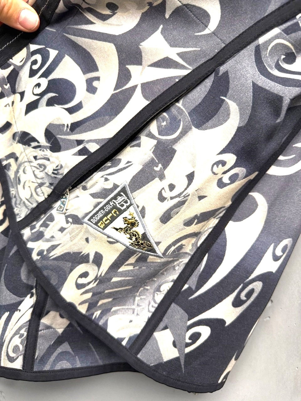 BERLIN VINTAGE CORNER grey, black, and cream tribal print zip-up jacket with embroidered chest detail.