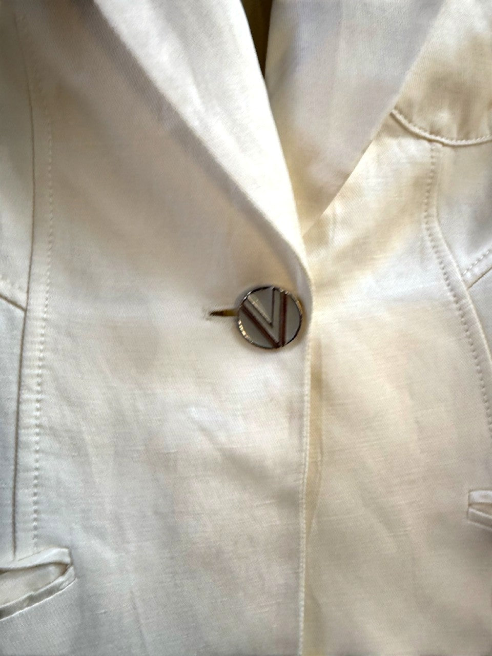 BERLIN VINTAGE CORNER Versace silver-tone V logo button and frayed welt pocket edge.