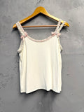 BERLIN VINTAGE CORNER white knit camisole with pink bow and rhinestone embellished spaghetti straps and braided trim.