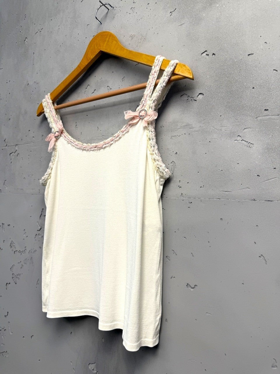 BERLIN VINTAGE CORNER white knit camisole with pink bow and rhinestone embellished spaghetti straps and braided trim.