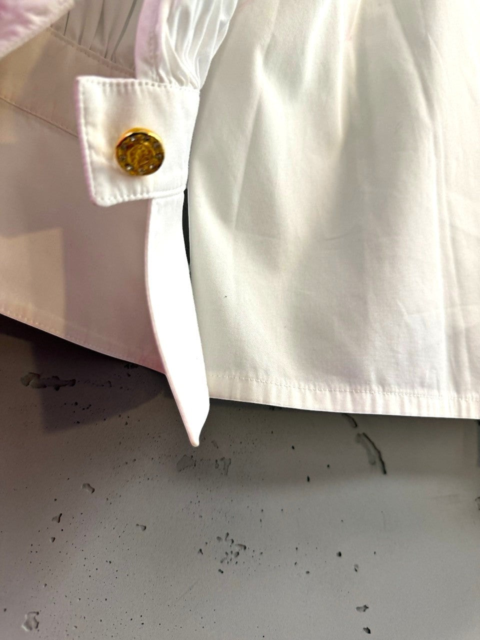 BERLIN VINTAGE CORNER white cotton blend blouse with ruched cuffs and gold-tone button detail.