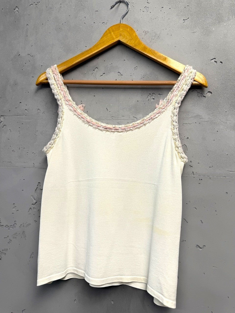 BERLIN VINTAGE CORNER white knit camisole with pink bow embellished straps and braided trim.