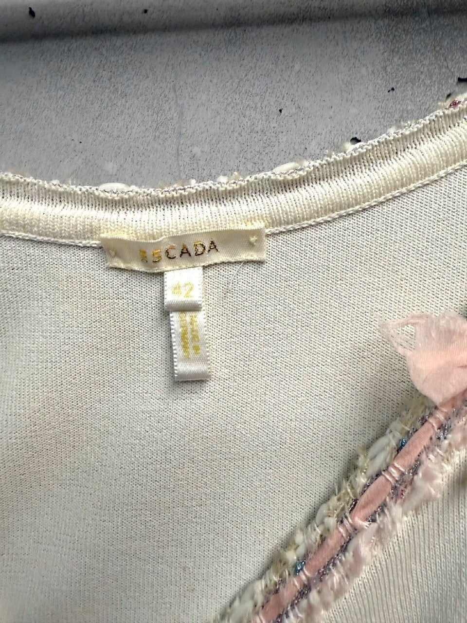 BERLIN VINTAGE CORNER white knit camisole with pink bow embellishments and textured braid trim.