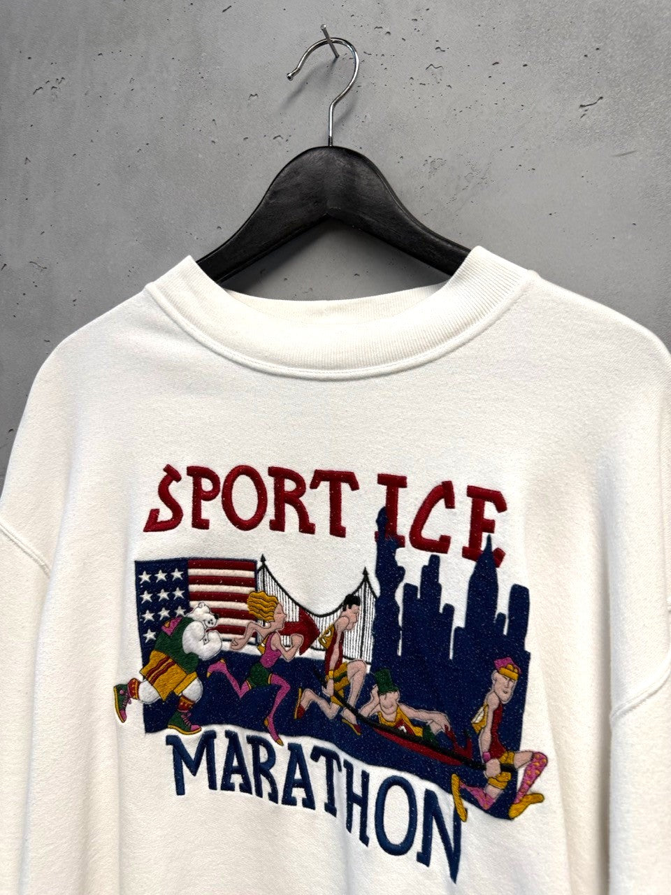 BERLIN VINTAGE CORNER white crewneck sweatshirt with Sport Ice Marathon graphic, American flag, and cityscape with runners.
