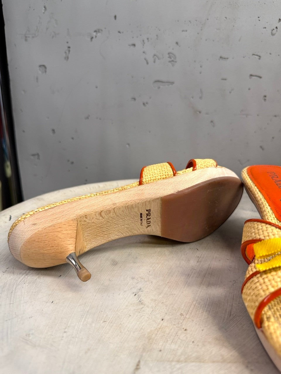BERLIN VINTAGE CORNER woven raffia slide sandals with orange trim, yellow bow accent, wooden platform and metallic stiletto heel.