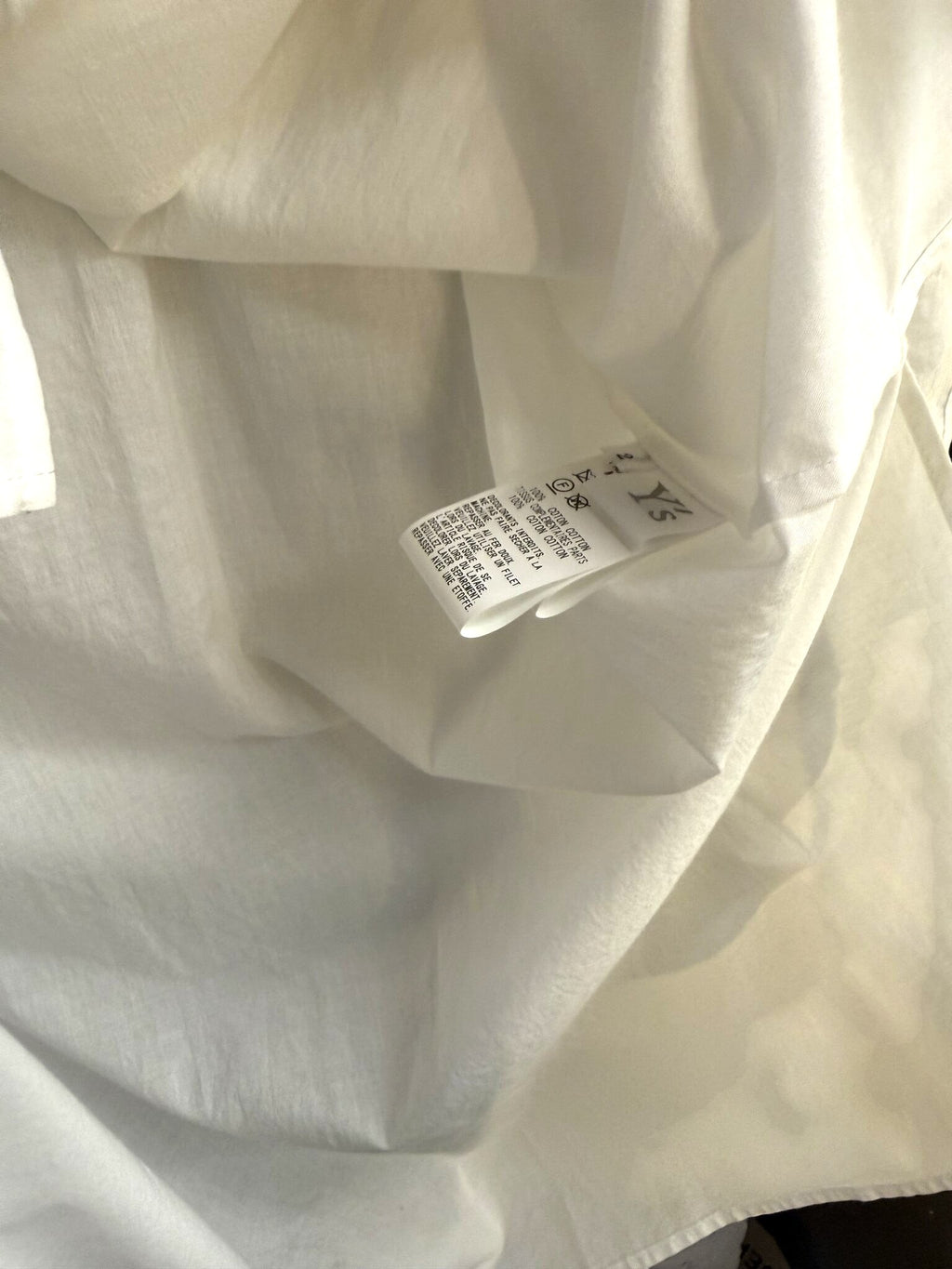 BERLIN VINTAGE CORNER Y's oversized white cotton shirt interior care label showing fabric composition and instructions