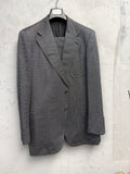 BERLIN VINTAGE CORNER Yves Saint Laurent Rive Gauche grey micro-dot wool blend suit. Features notched lapel, two-button jacket, and tailored trousers.